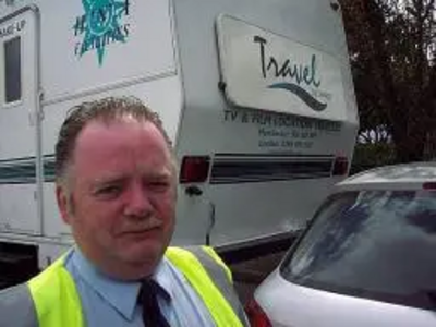 A BBC Security guard is surprised after film crew trailors were mistaken for illegal travellers' caravans