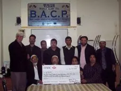 Paul Rowen presents the £4,000 cheque to members of the Bangladesh Association and Community Project