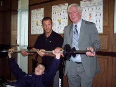 Paul tries out the Gym Equipment with a member of staff and a student.