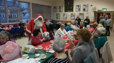 Santa Claus hands out presents at the Village Unite event