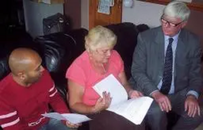 Plan of action: Buersil Post master Jay Patel, resident Carol Hoye and Rochdale MP Paul Rowen go through their plans to try and save their local Post Office